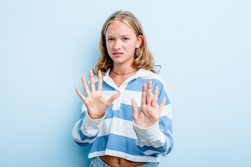 Caucasian teen girl isolated on blue background rejecting someone showing a gesture of disgust.