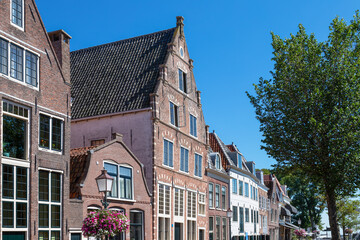 Row of canal houses along a canal in the dutch historic city of Hoorn.