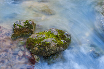 closeup mountain river rushing over a stones