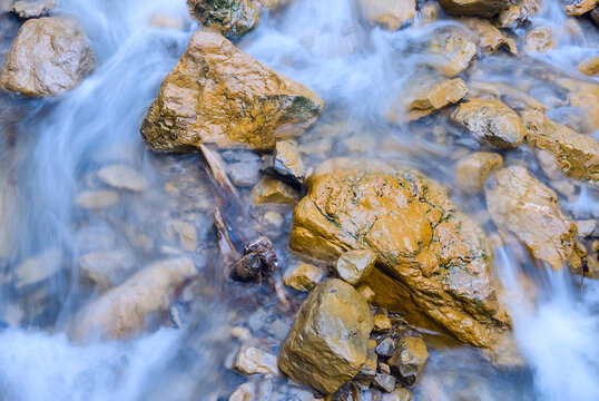closeup mountain river rushing over a stones