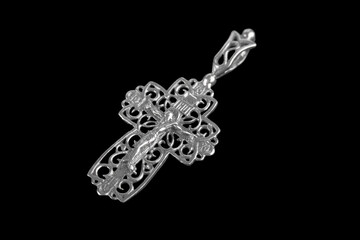 Fototapeta premium Silver crucifix necklace cross isolated on black background