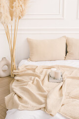 Beige muslin bedspread and pillowcases. Natural. Home textiles made of natural fabrics - obrazy, fototapety, plakaty