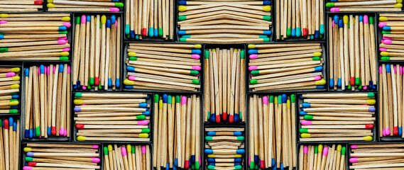 multicolored match sticks in boxes on a black background