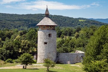 Beautiful, round medieval tower of Dreznik fortress, rising on the cliff above Korana river canyon in the woods, near town of Rakovica, Croatia