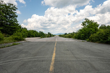 Fototapeta premium Long, aeroplane runway at the forsaken and abandoned Zeljava military airbase, Croatia, now popular tourist destination for bikers and adventure seekers