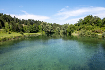 Fototapeta na wymiar Beautiful, turquoise coloured Korana river, flowing through the green forests of Lika, mountain region of Croatia near famous Plitvice lakes