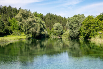 Fototapeta premium Beautiful, turquoise coloured Korana river, flowing through the green forests of Lika, mountain region of Croatia near famous Plitvice lakes