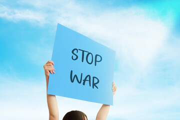  an activist holding a banner saying Stop War