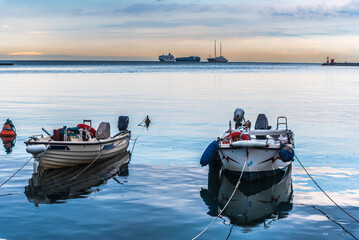 fishing boats at sunset in the harbor of trieste, italy