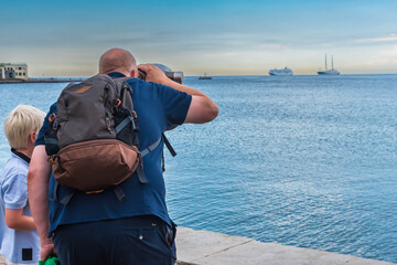 Obraz premium person watching ships at the coastline in trieste, italy