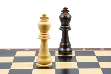 Two chess kings stand next to each other on a chessboard. Close-up. The concept of confrontation.