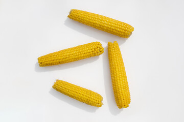 boiled corn lies on a white background
