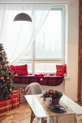 Large Window with Red Blanket and Pillows. Breakfast on Table is Decorated on New Year's Eve