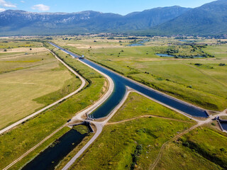 Aerial drone view of water canal in the field. Aqueduct irrigation canal. River in field. 