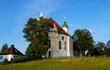 The Pilgrimage Church of Wies (German: Wieskirche) is an oval rococo church in the Bavarian Alps on a sunny day in August (Steingaden, Weilheim-Schongau district, Bavaria, Germany)