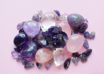 Gemstone minerals on a pink background. Round tumbling minerals amethyst, amethyst druse and rose...