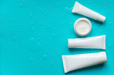 Moisturizing cream on a blue background. Selective focus.