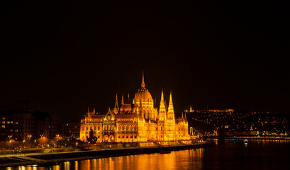 Fototapeta na wymiar 20.03.2022 Budapest, Hungary. View to National Parliament on Danube River from Fisherman Bastion. Evening and night photo. 