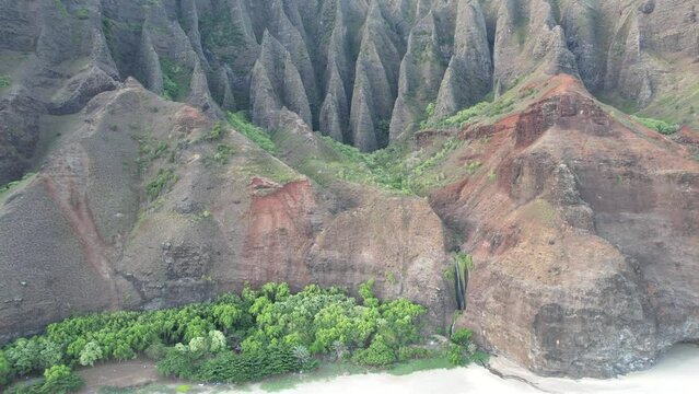 Drone aerial over the Na Pali Coast of Kauai, Hawaii, with secluded beaches buttressed by mountains, accessible only by hiking or boat