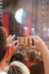 Recording a concert using a mobile phone. Smartphone at music show.