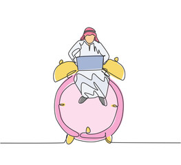 Single continuous line drawing young Arab business man sitting on big analog alarm clock and typing on laptop. Business discipline metaphor concept. One line draw graphic design vector illustration.