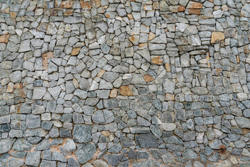 The wall was built of roughly worked multi-colored stone.