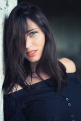 Fototapeta premium Portrait of beautiful young woman with green eyes and long brown hair