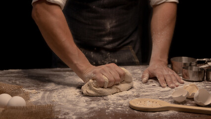 baker kneading dough