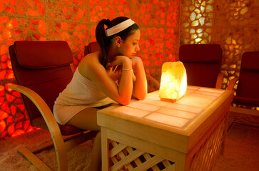 Beautiful woman enjoying salt therapy and beauty treatment in beauty spa