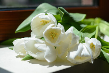 Obraz na płótnie Canvas Bouquet of beautiful white tulip flowers on windowsill indoors, closeup