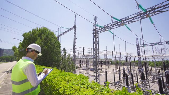 Engineer inspecting the switchyard.
Engineer inspecting switchyard at nuclear power plant.
