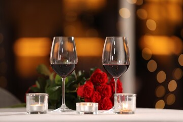 Glasses of wine for romantic dinner on table in restaurant