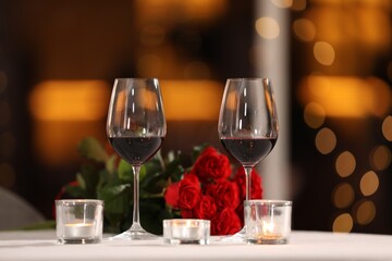 Glasses of wine for romantic dinner on table in restaurant