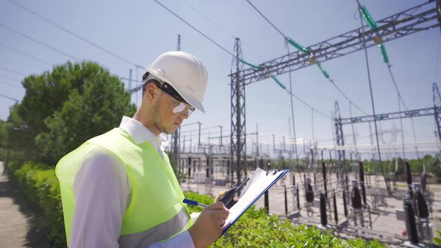 Engineer works at nuclear power plant.
Engineer working in the switchyard of the power generation plant.
