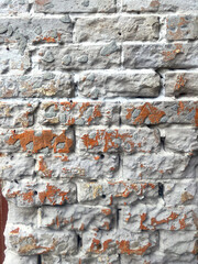 Weathered bricks painted white on a sunny day with shadows