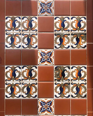 Classical Spanish tiles with floral patters from an old Cuban building in terracotta red, white, blues, reef and yellow