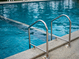 .Stainless steel stairs to the pool. handrails up and down the pool.