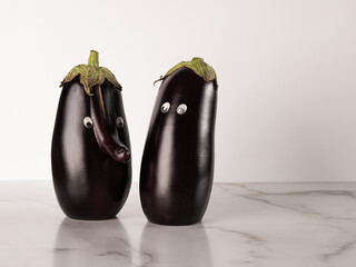 Two anthropomorphic eggplants hanging out together 
