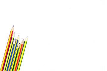 Fototapeta premium multi colored pencils placed on a white background