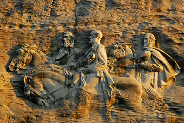 Jackson, and Jefferson Davis, ride horseback at a controversial carving at Stone Mountain, Georgia,...
