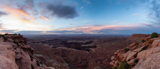 Scenic Panoramic View of American Landscape and Red Rock Mountains in Desert Canyon. Cloudy Sunrise Sky. Canyonlands National Park. Utah, United States. Nature Background Panorama