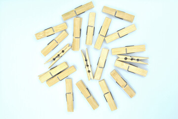 A clothes peg made of bamboo is placed on a white background.