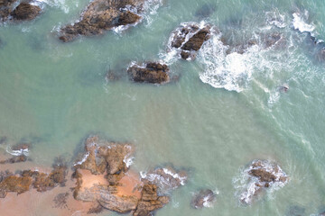 aerial view of sea and ocean waves near the beach Sea water hitting rocks on the beach Looks impressive, the beauty of the sea