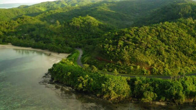 Aerial Panning Shot Of Road On Green Mountains, Drone Flying Over Sea - Suva, Fiji
