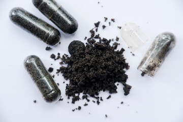 Black cumin capsules or commonly called Black Seed isolated on a black background. One of the...
