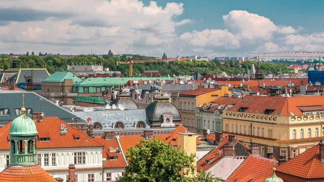 Red roofs of the city Prague timelapse shot from the high point on Old Town Bridge Tower. Cloudy sky at summer day