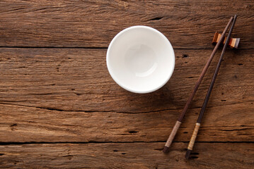 ceramic blank bowl  and chopsticks on dark table