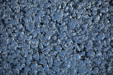 Black asphalt, texture. The resin is a garnet crumb.