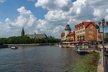 View of the fishing village on the embankment of the Pregolya River on a sunny summer day,...