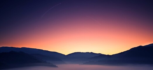Fototapeta na wymiar Mountains before dawn. Dawns in the sky and fog in the valley.